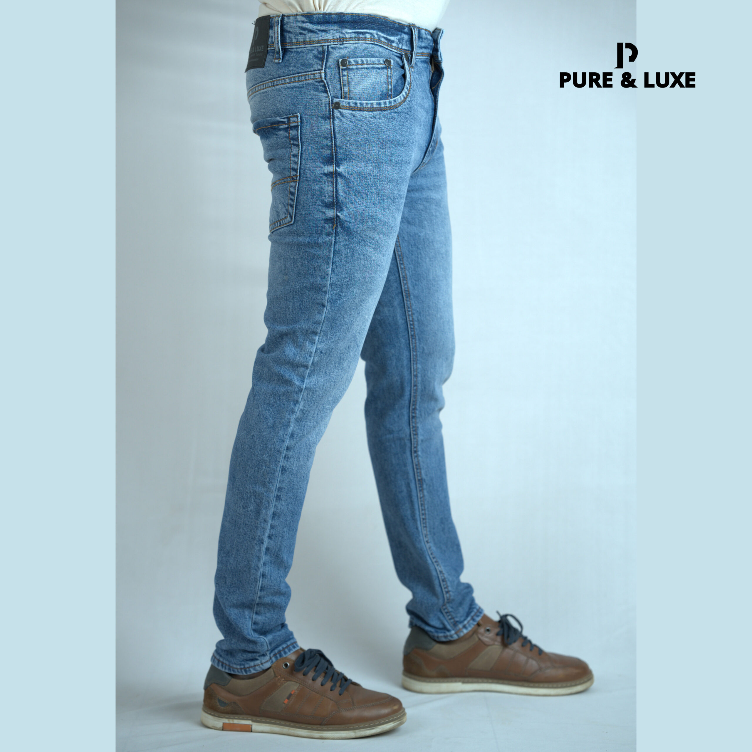 Slim Fit Blue Jeans for men by Pure & Luxe, featuring a light blue wash, modern slim cut, and comfortable stretch denim.