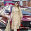 Model wearing a champagne gold embroidered kurti set with floral detailing, part of Jubaida’s Collection by Pure & Luxe, standing in front of a red SUV