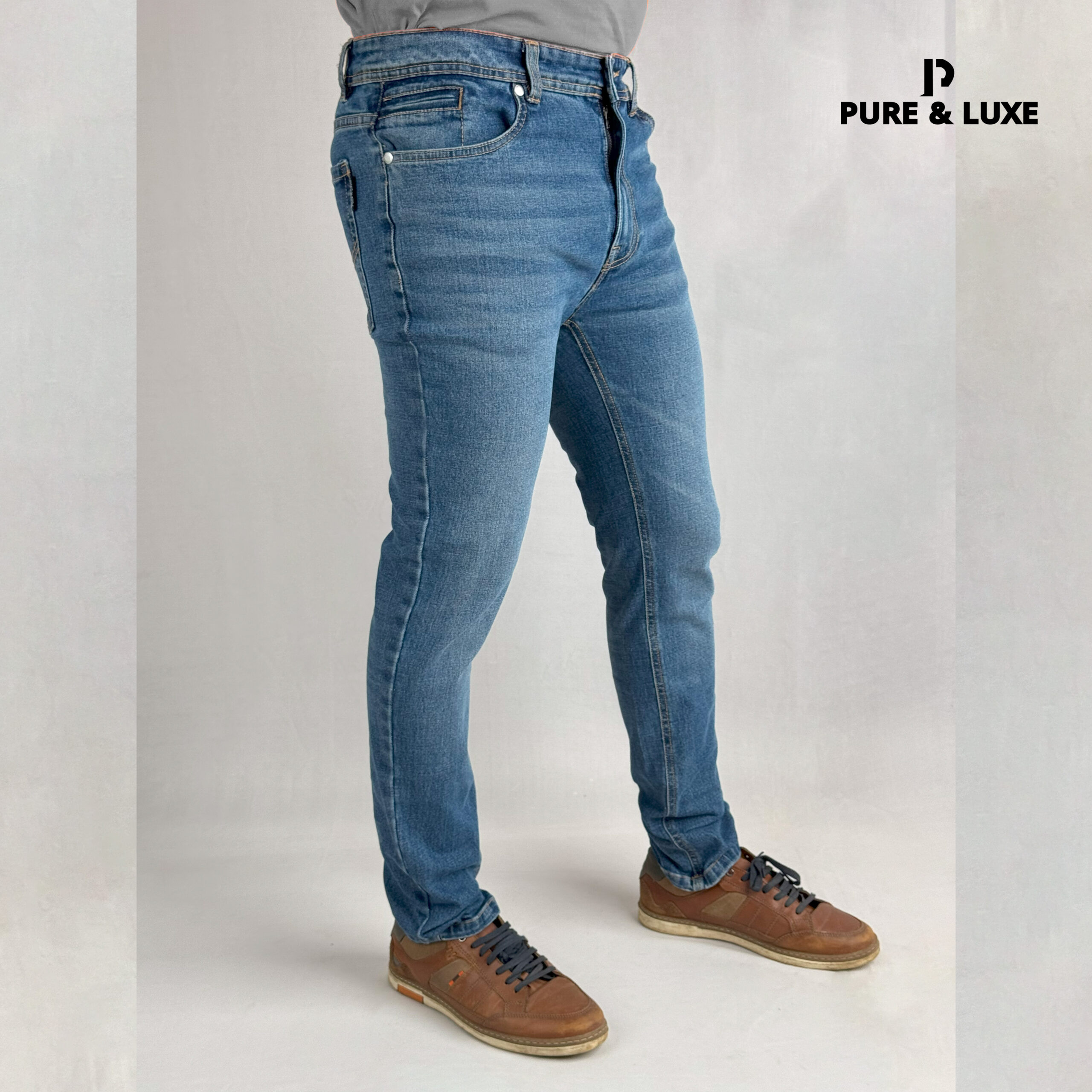 Right side view on model (deep blue jeans with clean look)