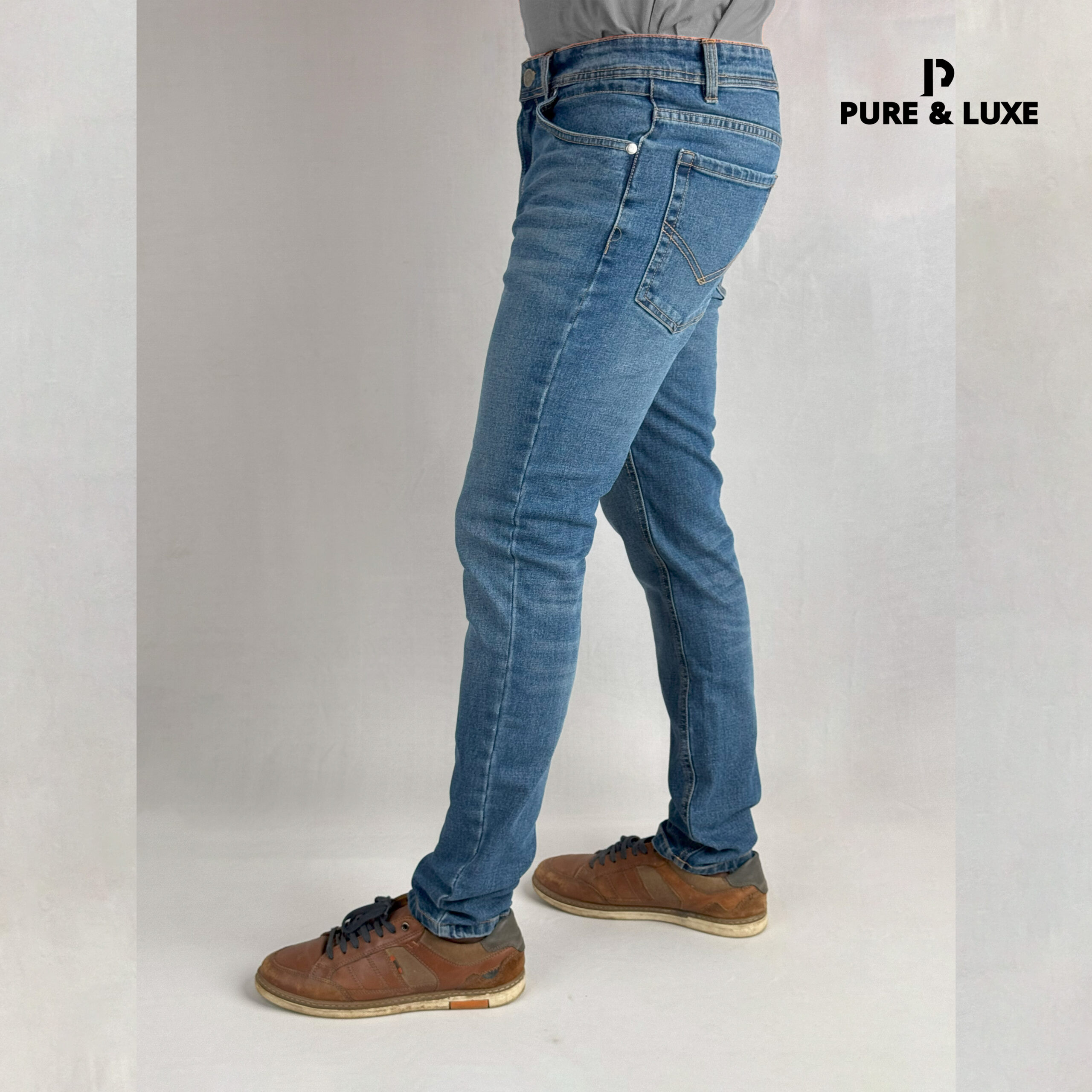 Left side view on model (deep blue jeans with clean look)