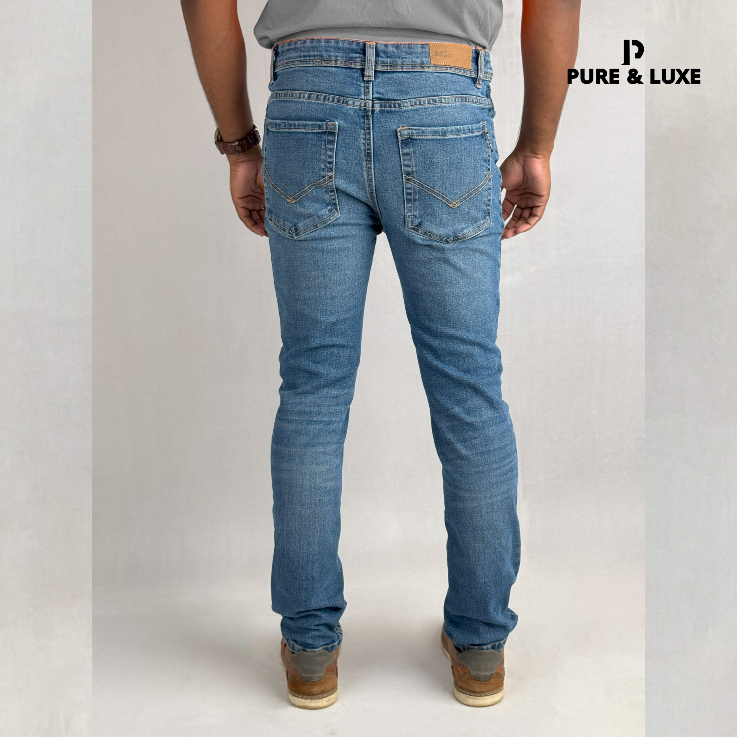 Back view on model (deep blue jeans with clean look)