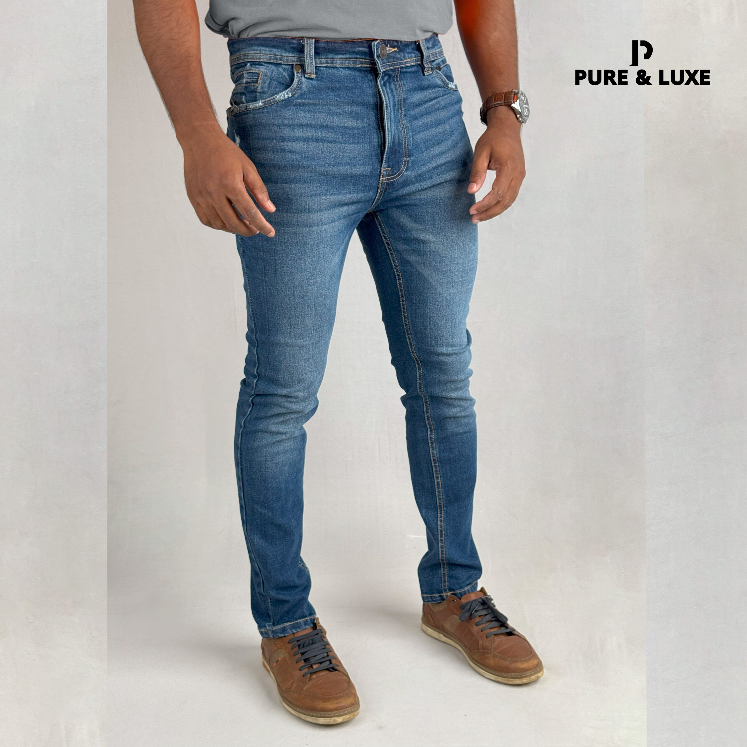 Man wearing Hard Grind Indigo Slim Fit Jeans by Pure & Luxe – right front view